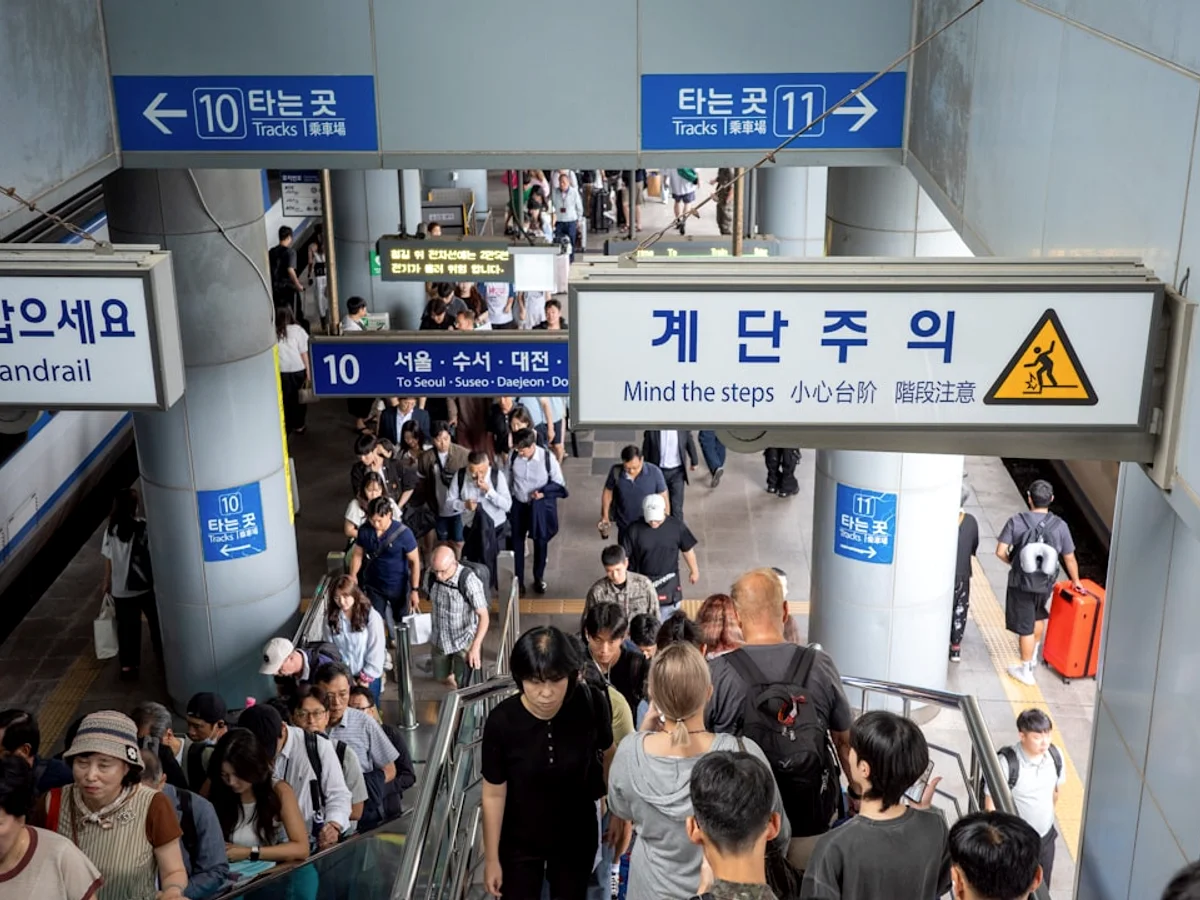 People walk through a subway entrance in south korea.