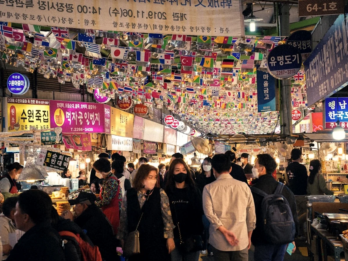 A group of people in a market related to Korean payment methods credit