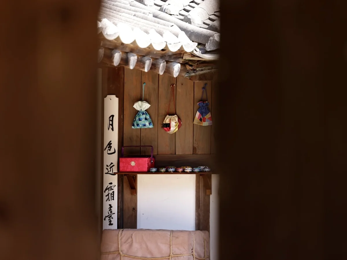 A room with a rack of skis and ski poles