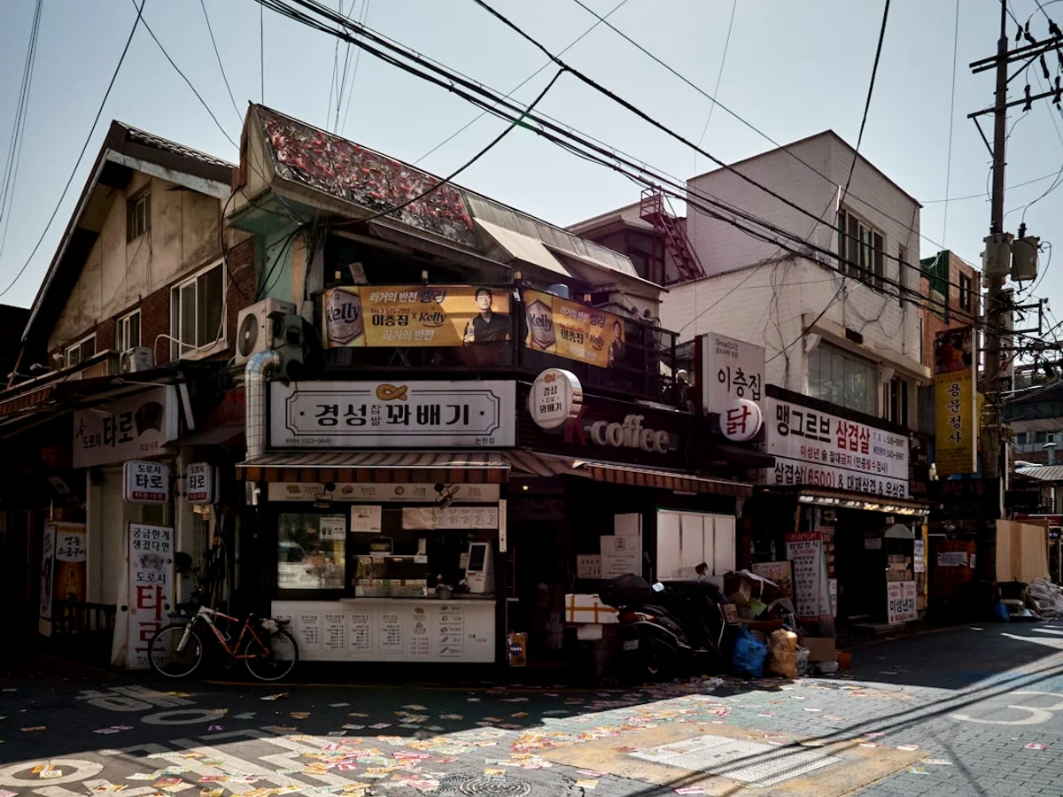a street corner with a building and a bicycle parked in front of it