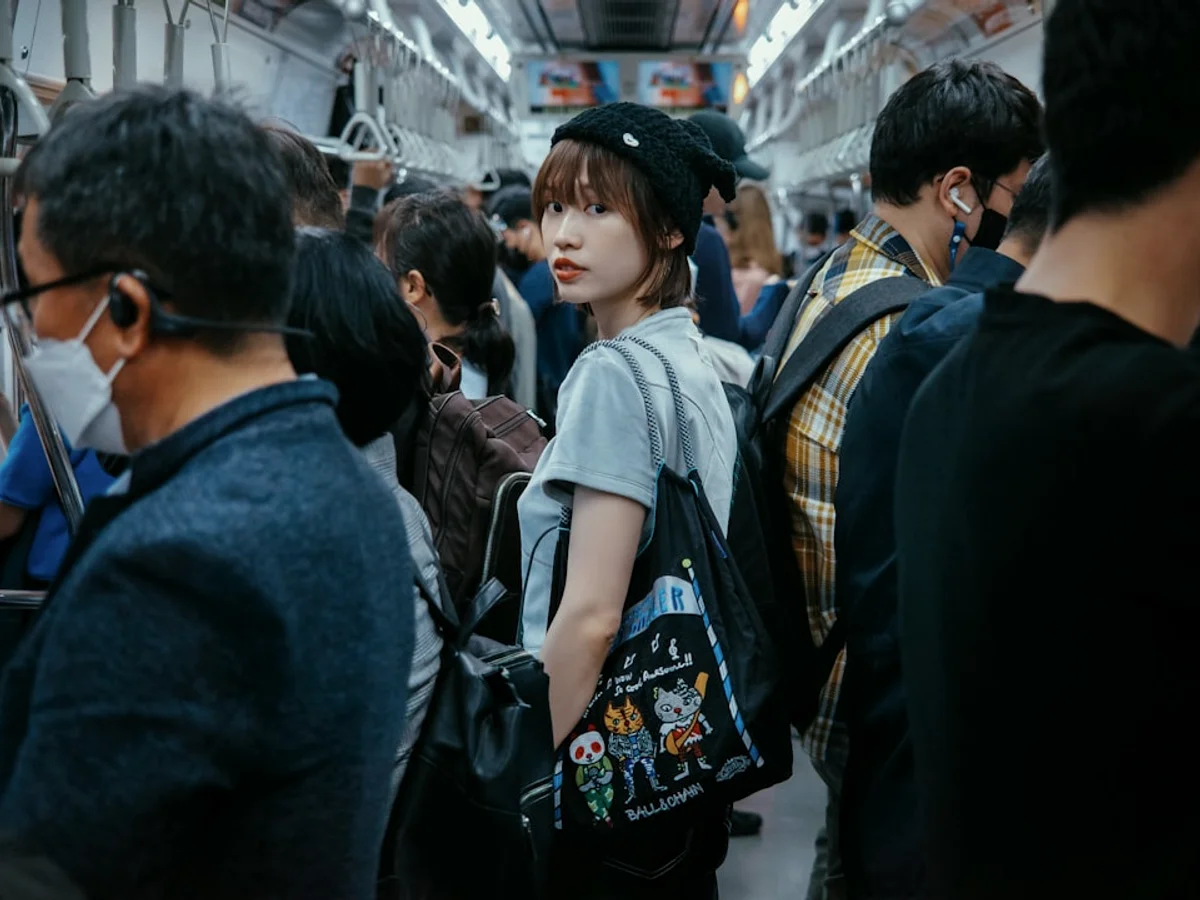 A group of people standing on a subway train in Korea