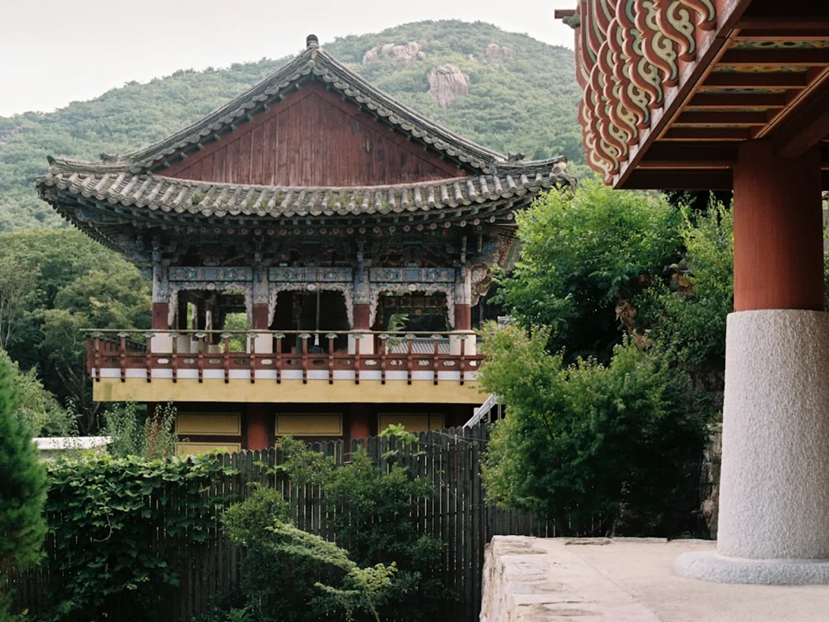 A view of a building with a mountain in the background