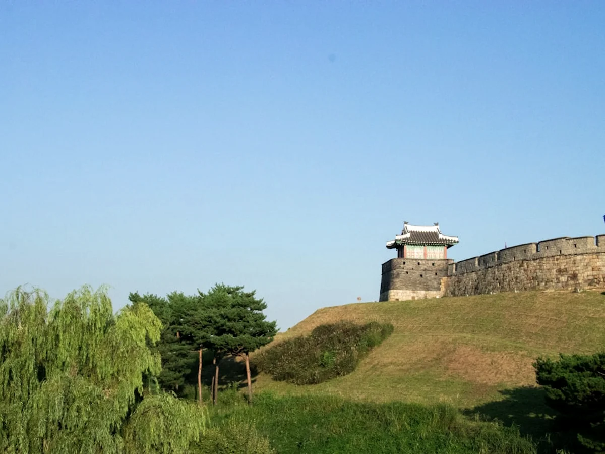 A tower on top of a grassy hill in Korea