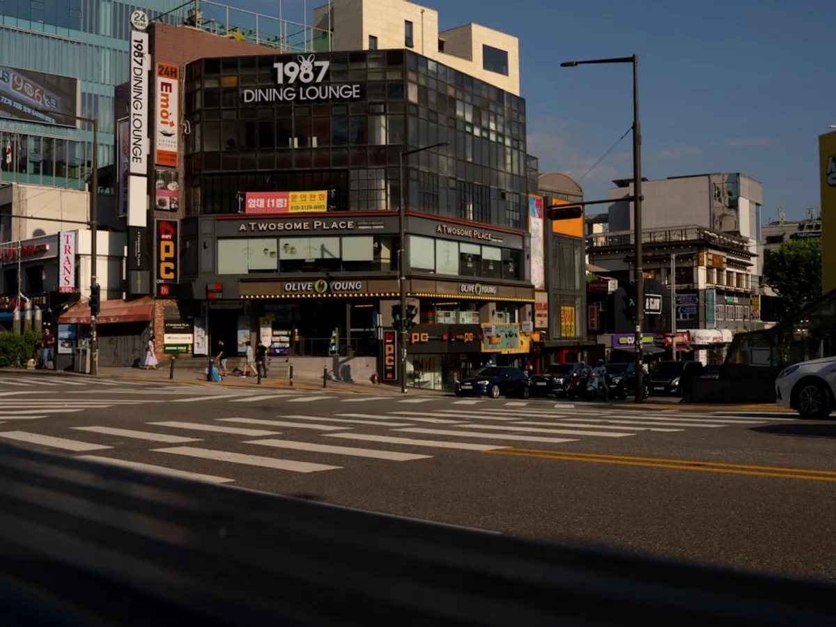 A street with cars and buildings on the side in Korea
