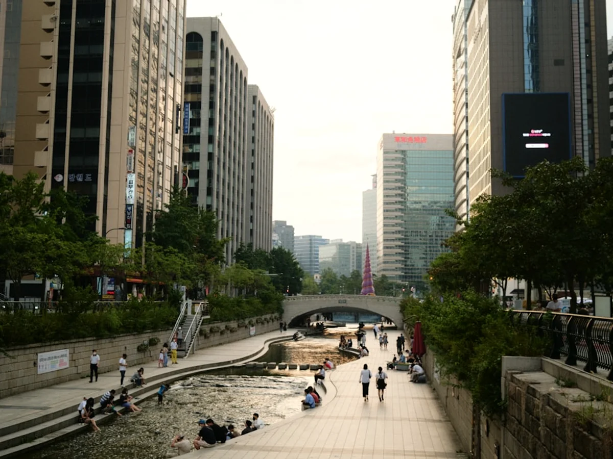people walking on sidewalk near high rise buildings during daytime